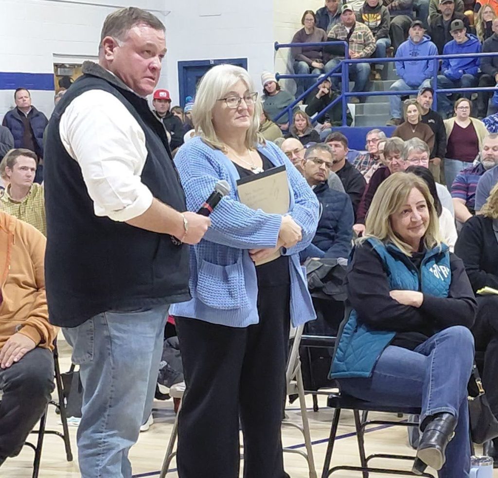 A group of several hundred people gathered in an auditorium for a town hall meeting regarding proposed data centers near Montgomery City and New Florence, with audience members expressing concern and skepticism.