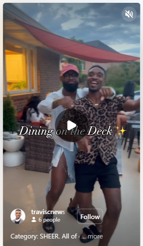 Two men dancing joyfully on a deck while a woman can be seen dining in the background; the scene captures a cheerful outdoor gathering.